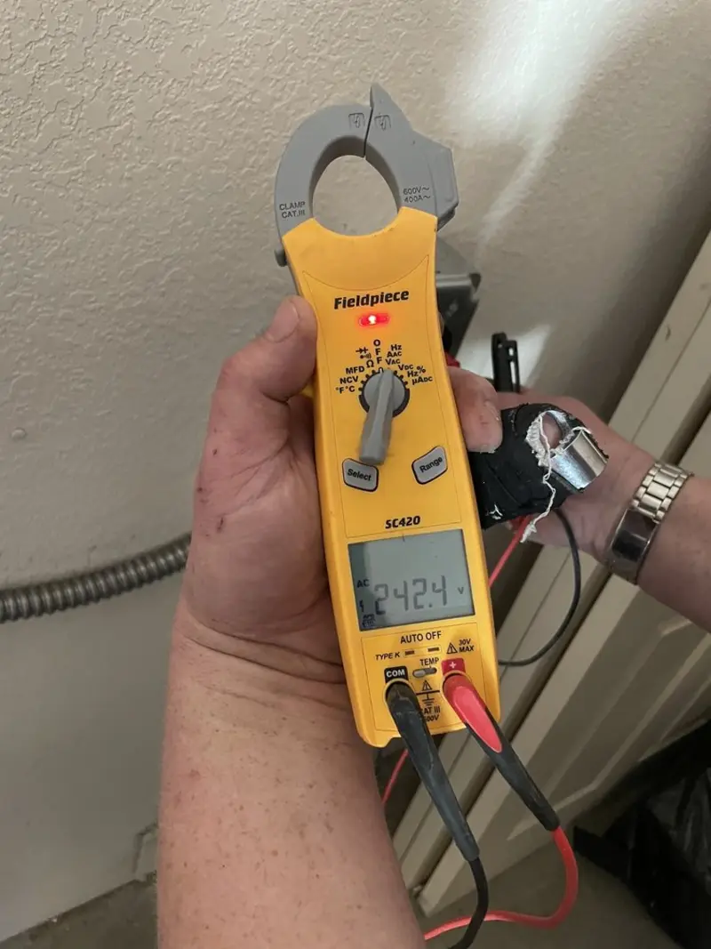 Voltage testing with clamp meter during Electrical Installation Services in Highland Acres